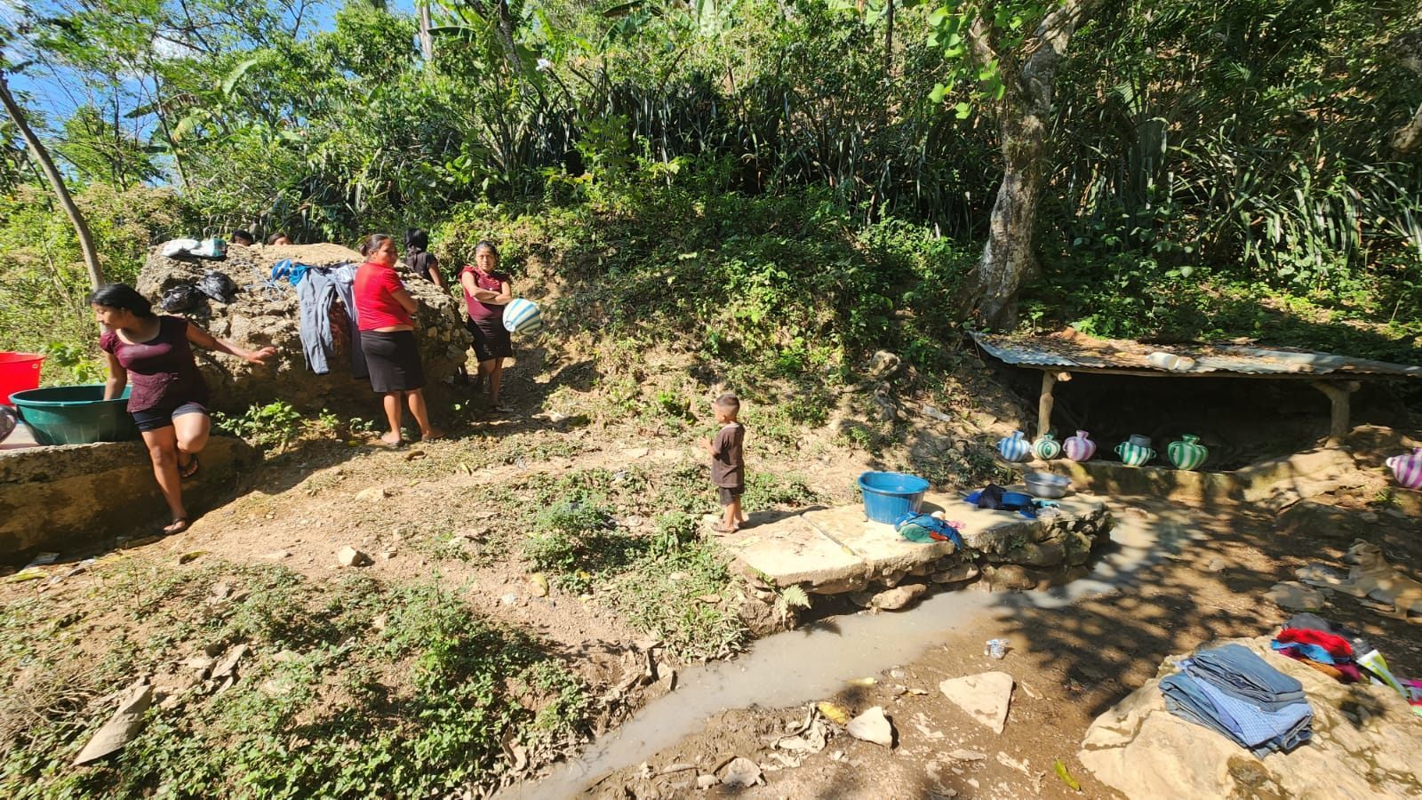 Families gathered near a water source in a rural Guatemalan territory